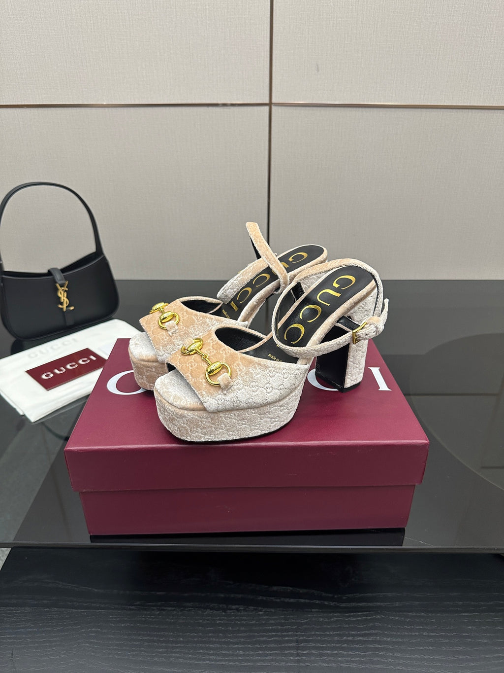 Pair of beige and gold platform sandals with chunky block heels and gold buckle detail