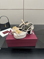 Pair of beige and gold platform sandals with chunky block heels and gold buckle detail