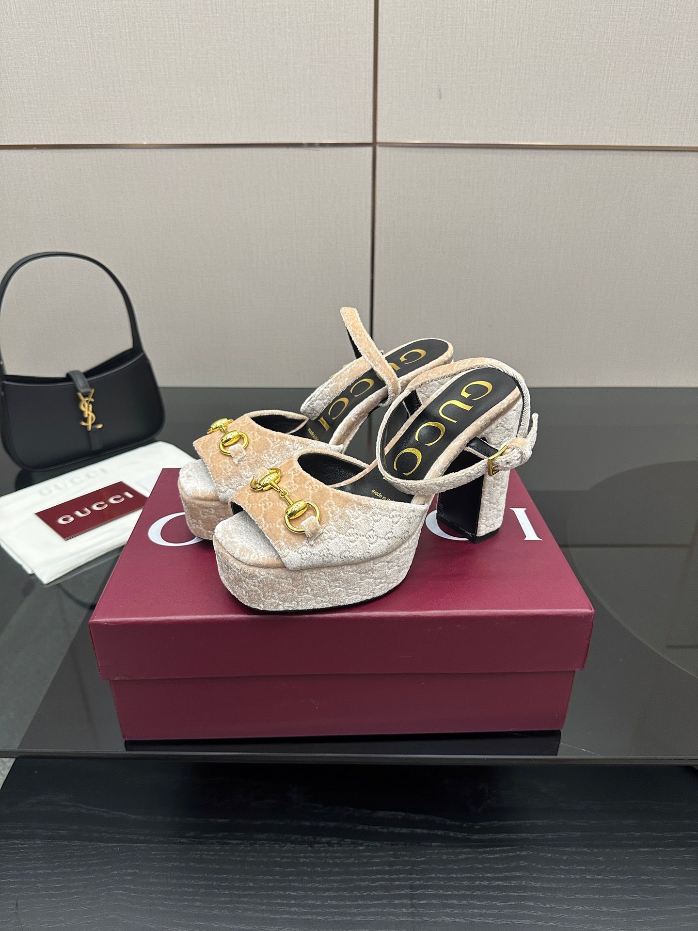 Pair of beige and gold platform sandals with chunky block heels and gold buckle detail