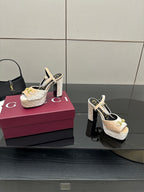 Beige and gold platform sandals with chunky heel, sling straps, and gold buckle detailing