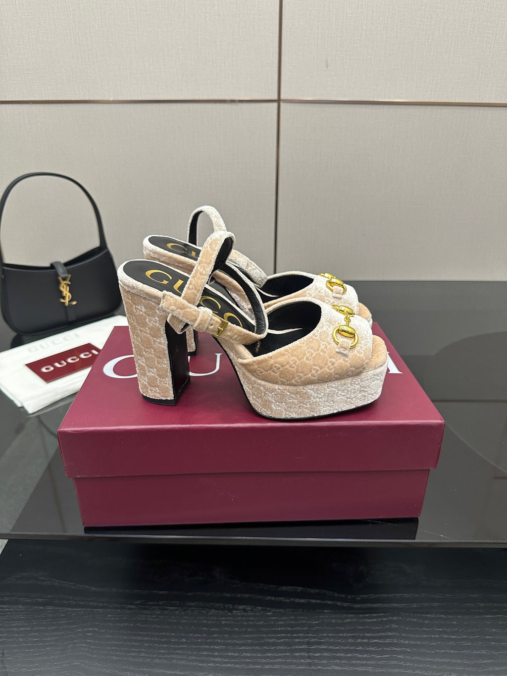 Beige and gold platform sandals on a display box, chunky heels and gold buckle straps