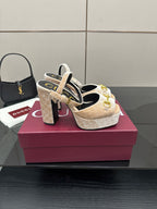 Beige and gold platform sandals on a display box, chunky heels and gold buckle straps