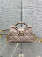 Beige quilted mini handbag with top handle and gold chain strap
