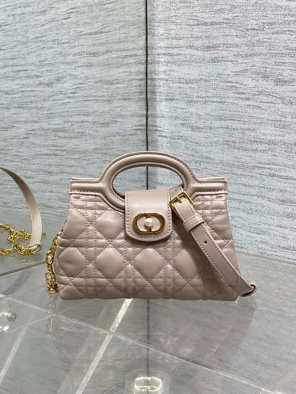 Beige quilted mini handbag with top handle and gold-tone clasp