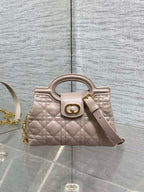 Beige quilted mini handbag with top handle and gold-tone clasp