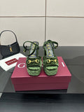 Gucci ladies green patterned platform heels with ankle straps and gold-tone hardware