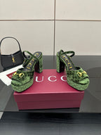 Gucci ladies green patterned platform heels, angled view with ankle strap and gold hardware