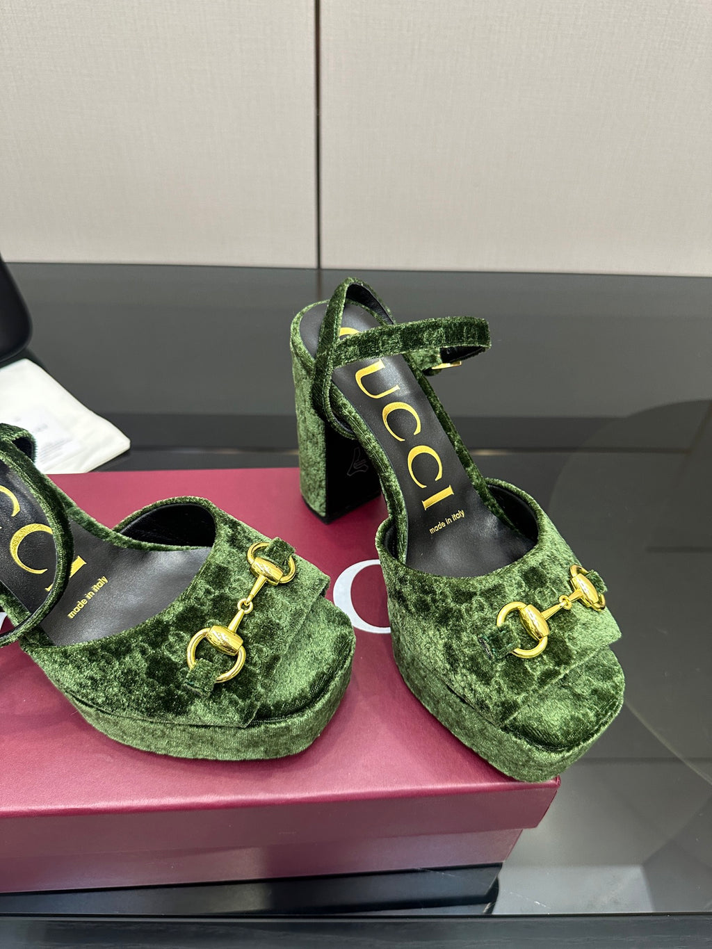 Gucci ladies green patterned platform heels, close-up of gold-tone hardware and straps