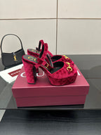 Red velvet platform heels with gold buckle detail and ankle strap, front view
