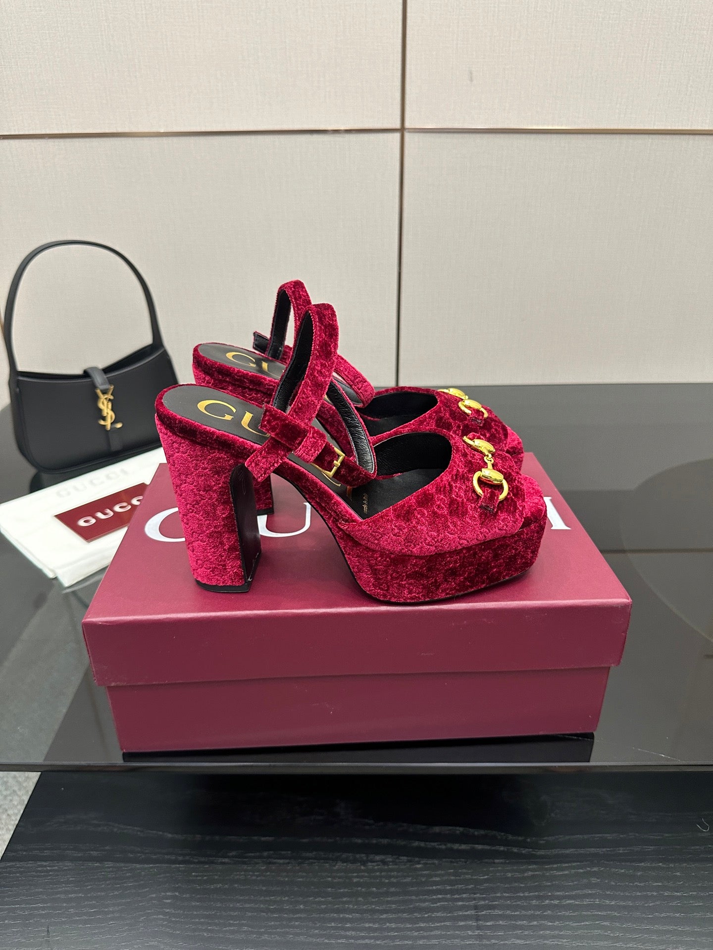 Red velvet platform heels with gold buckle detail and ankle strap, front view