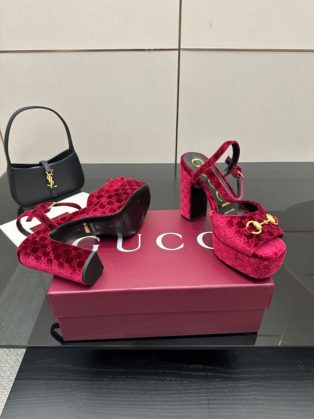 Red velvet platform heels with gold buckle detail on block heel, front view
