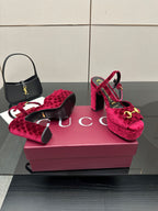 Red velvet platform heels with gold buckle detail on block heel, front view