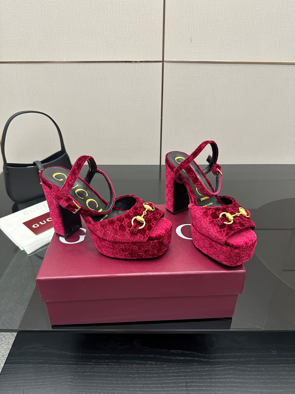 Red velvet platform heels with gold buckle accents and chunky block heel, angled