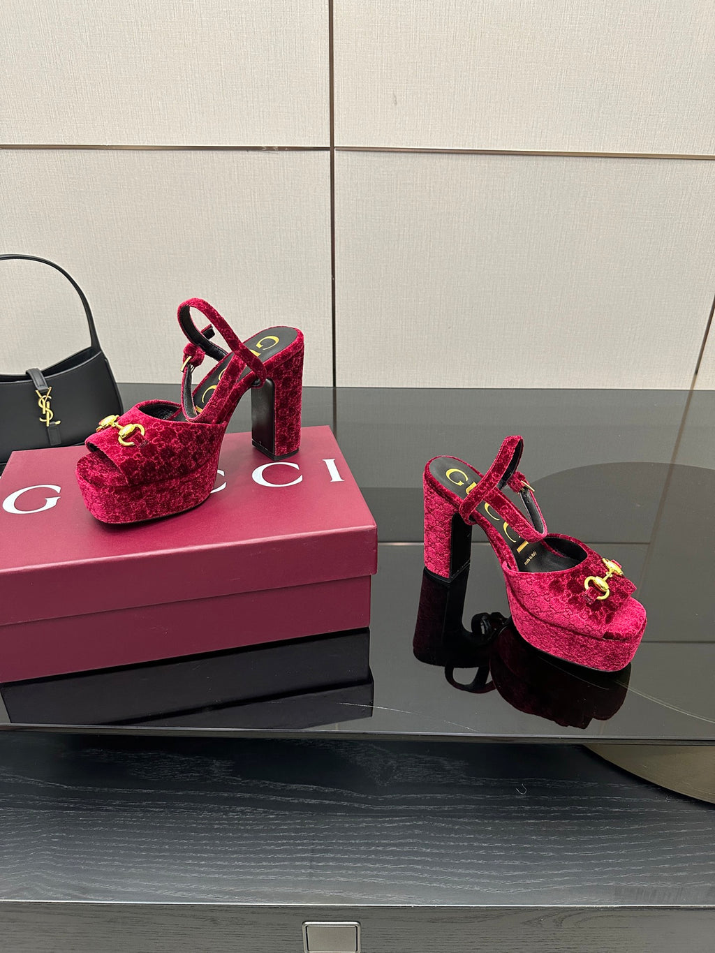 Red velvet platform heels with gold buckle detail and ankle strap, side-by-side view