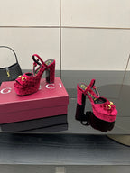 Red velvet platform heels with gold buckle detail and ankle strap, side-by-side view