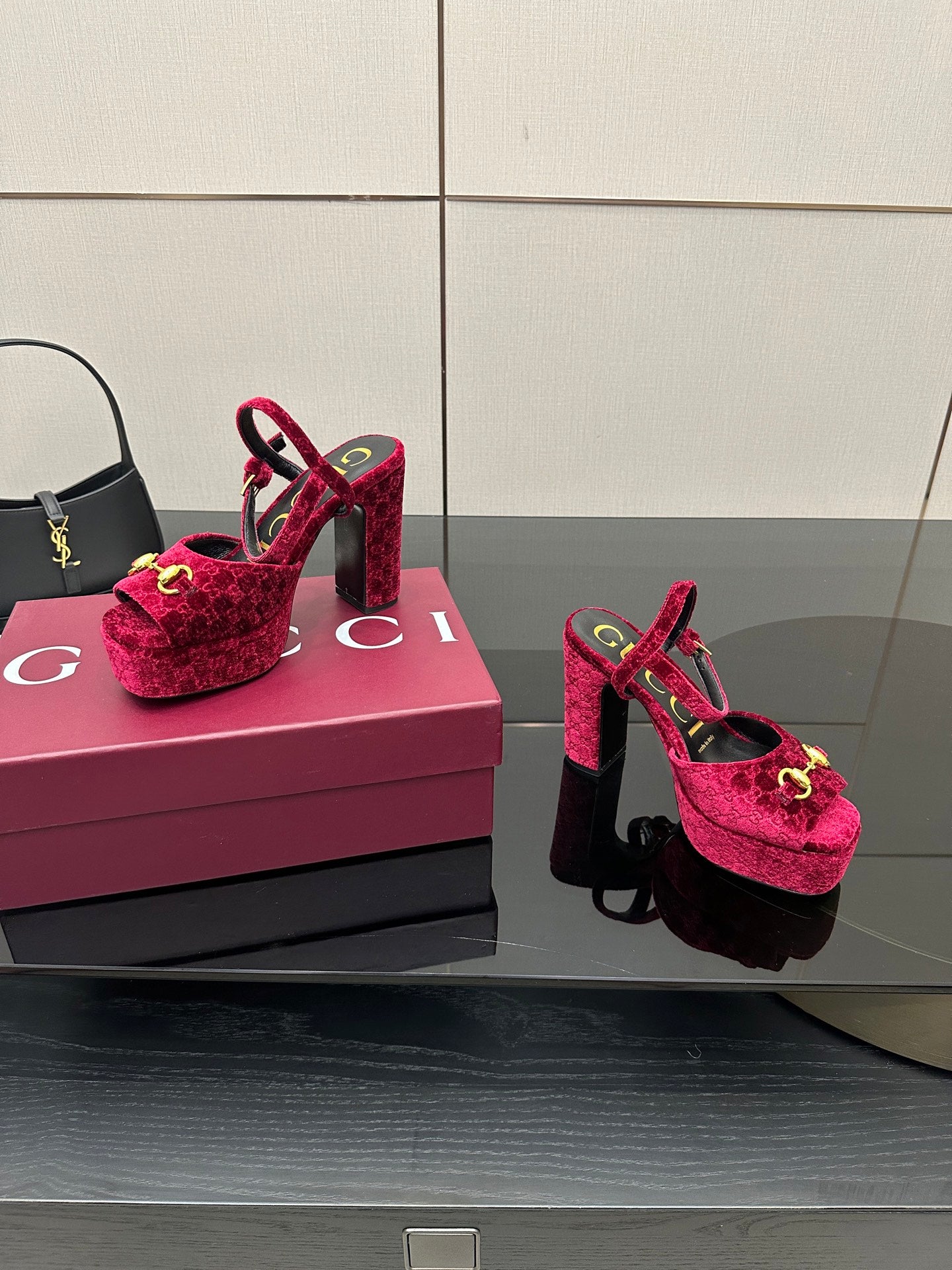 Red velvet platform heels with gold buckle detail and ankle strap, side-by-side view