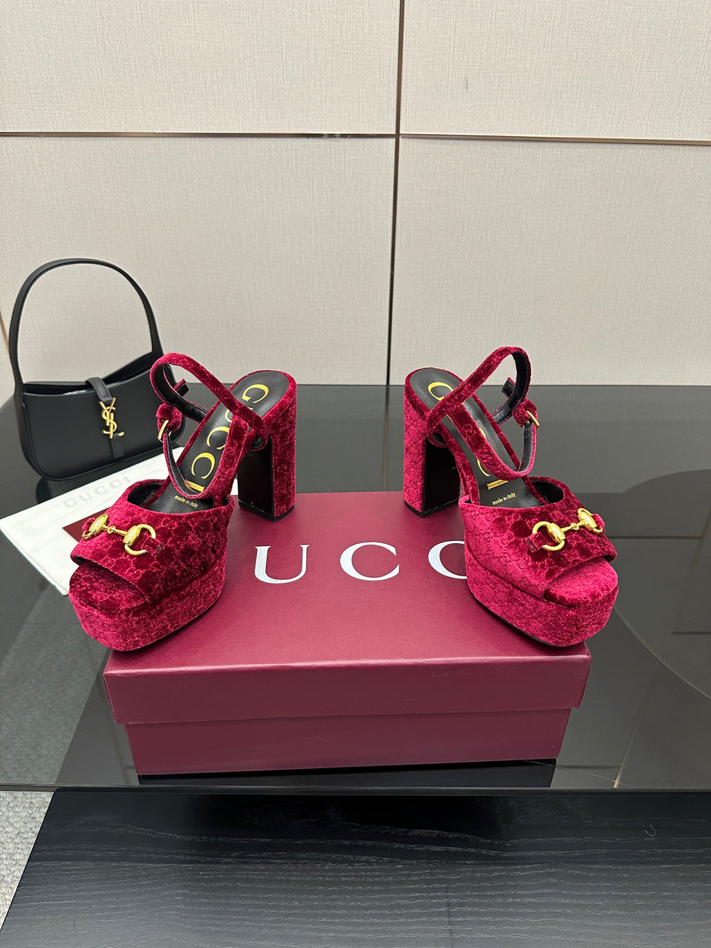 Red velvet platform heels with gold buckle detail and ankle strap, front-left view