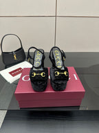 Gucci women's black heeled mules with gold buckle detail and cushioned platform