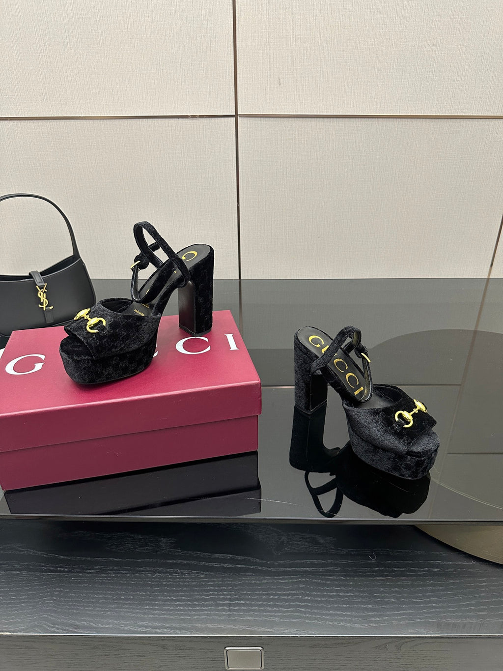 Gucci women’s black heeled mules with gold buckle detail and chunky block heel pair