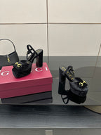 Gucci women’s black heeled mules with gold buckle detail and chunky block heel pair