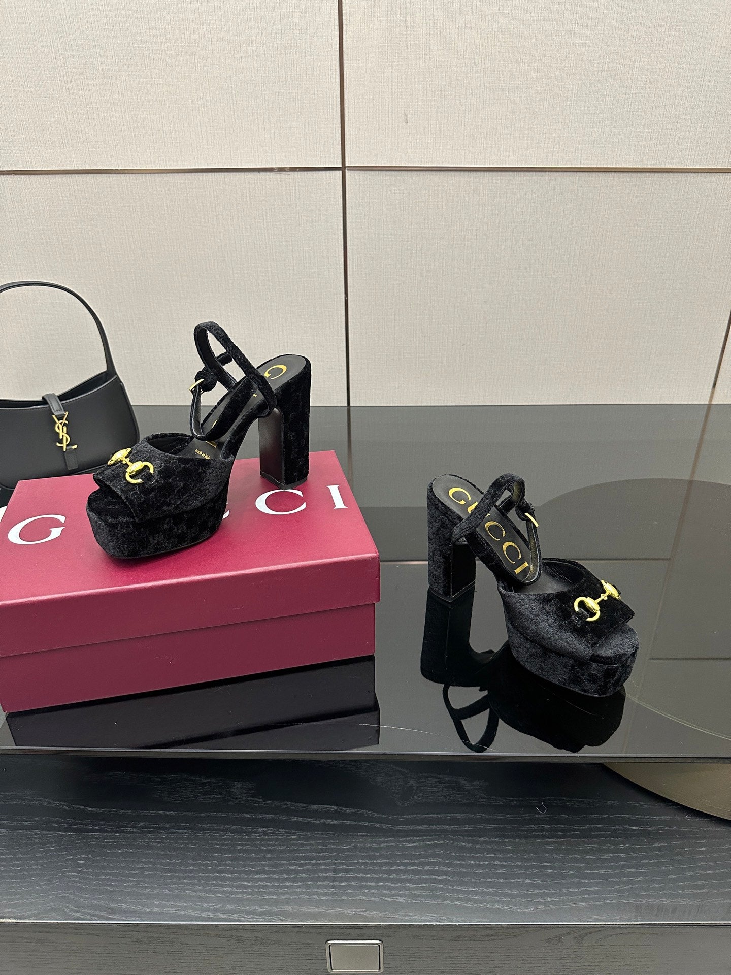 Gucci women’s black heeled mules with gold buckle detail and chunky block heel pair