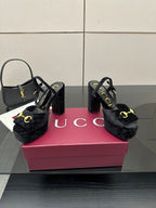 Gucci women’s black heeled mules with gold buckle strap and sturdy block heel
