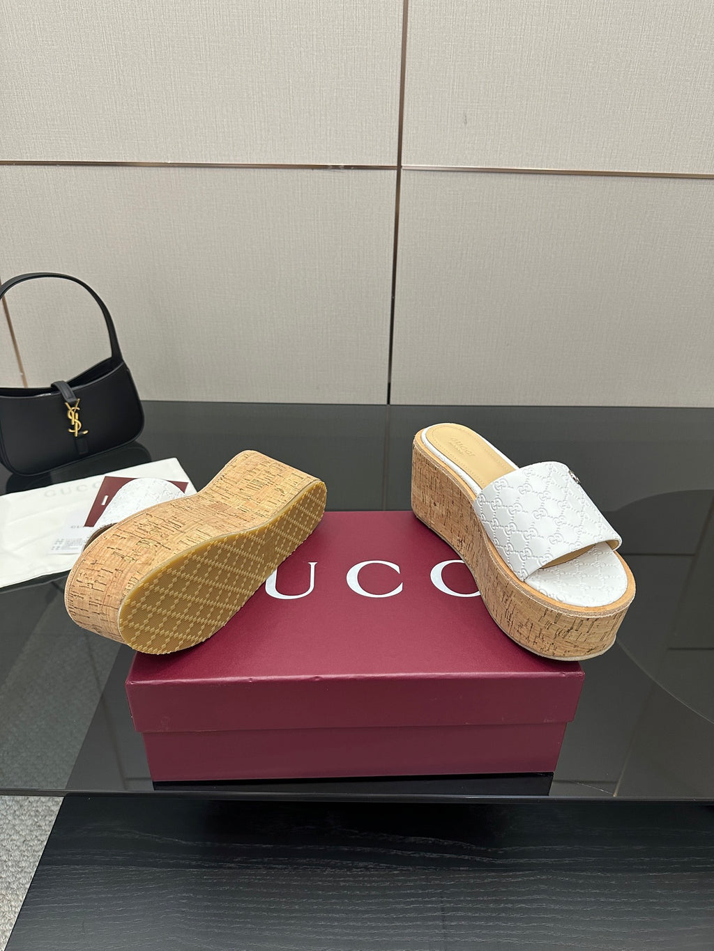 Gucci women's slide sandals, white upper, cork wedge; textured outsole view