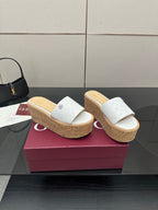 Gucci women's platform slide sandals, white upper with embossed pattern, cork wedge