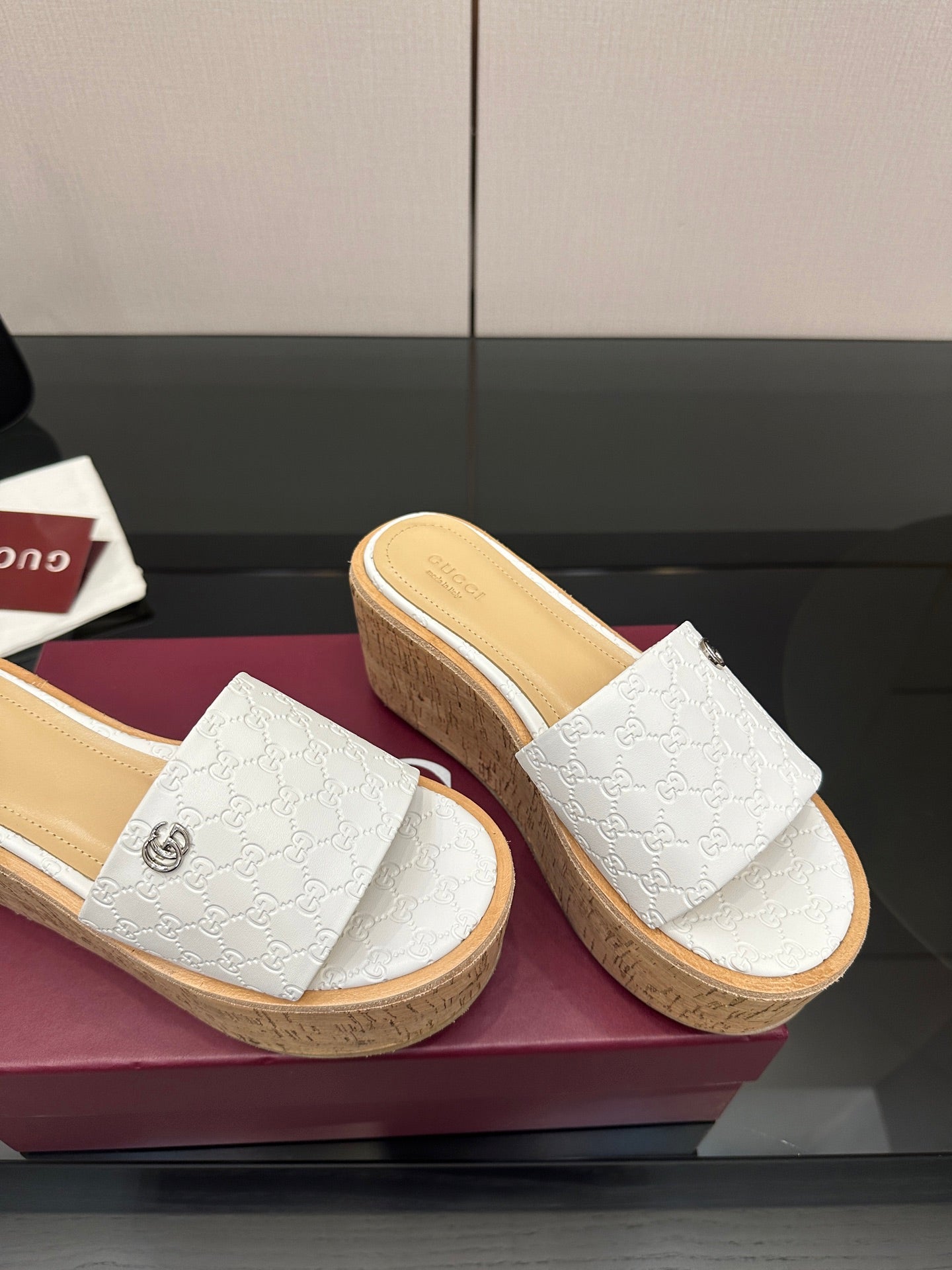 Gucci women's slide sandals, white embossed upper, cork wedge sole