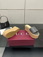 Gucci women’s platform slides in gray GG canvas, cork footbed and textured sole