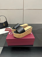 Gucci black GG slide sandals with cork wedge sole and wide strap, gold logo