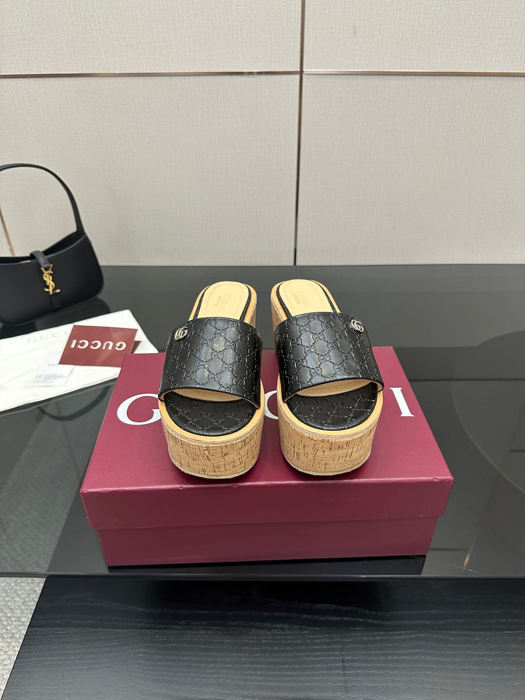 Gucci ladies black GG slide sandals with cork wedge platform and gold logo detail