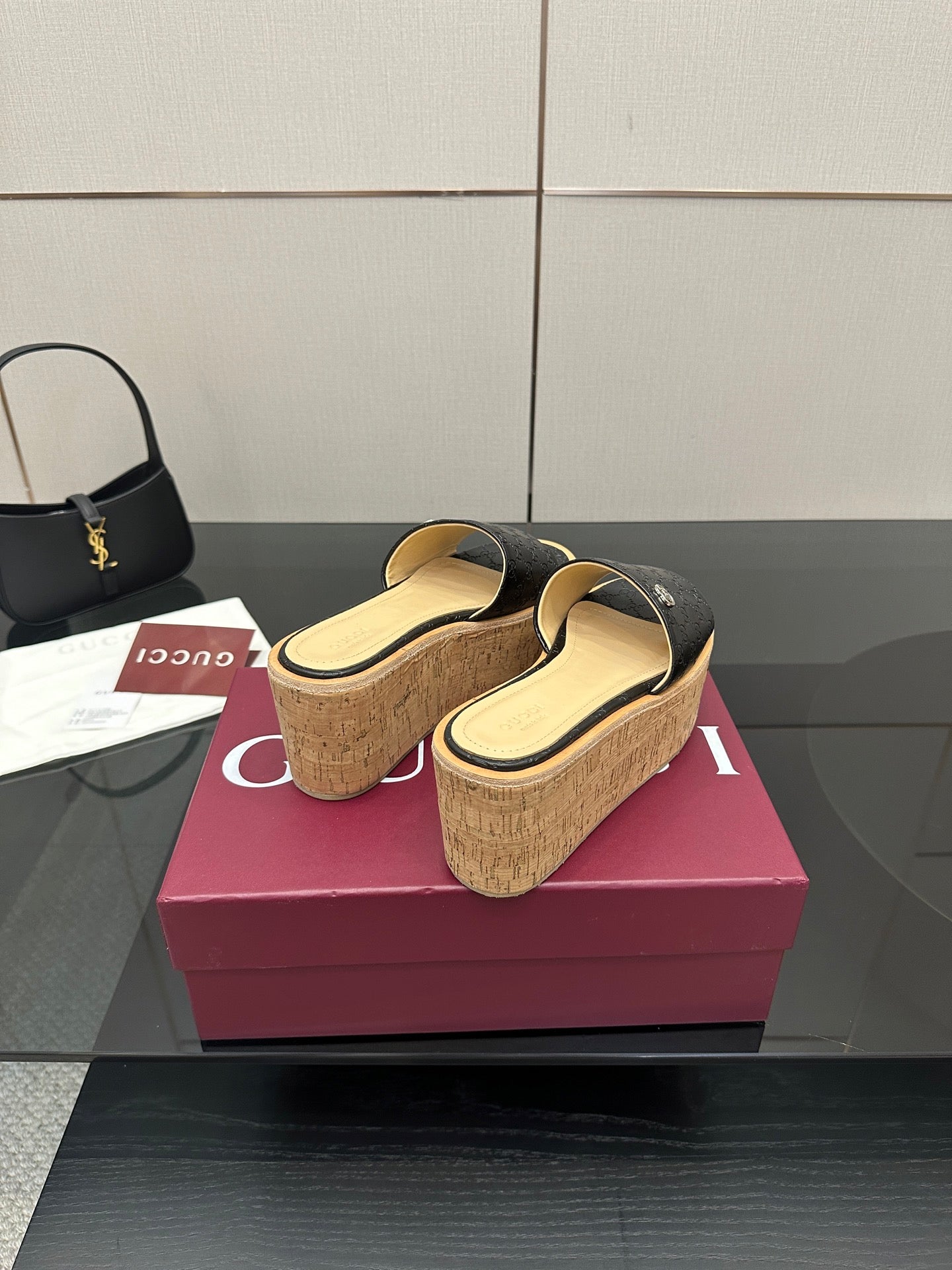 Gucci ladies black GG platform slide sandals with cork wedge and gold logo detail