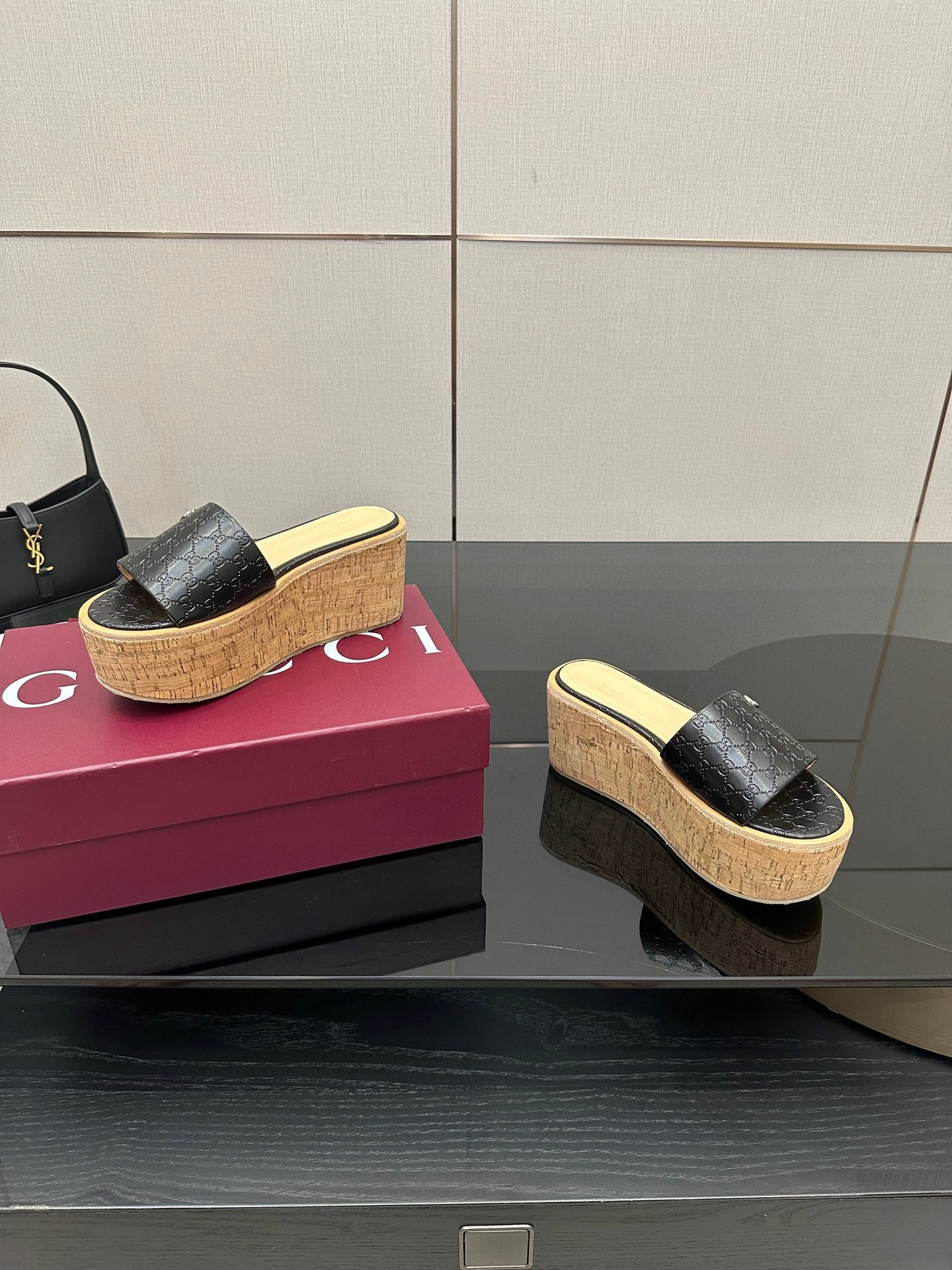 Gucci black GG slide sandals with cork wedge platform, open toe, gold logo