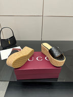 Gucci black GG slide sandals on cork wedge platform with textured sole