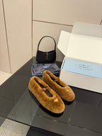 Women's tan suede flats with buckle strap, angled top view