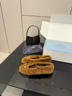 Women's tan suede flats with buckle strap, front view