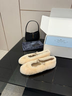 Prada ladies shearling loafers, cream fuzzy slip-ons with gold strap ornament