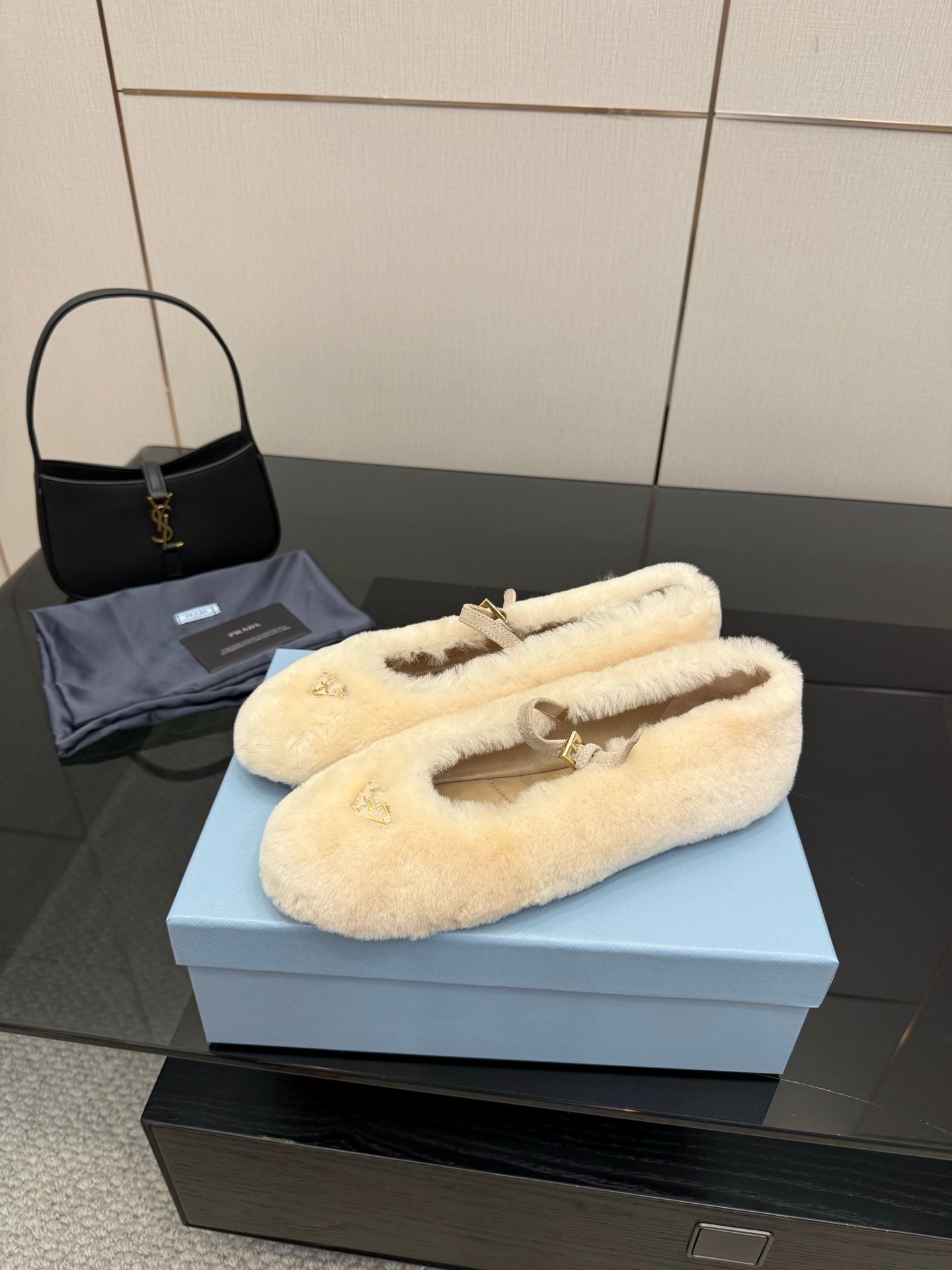 Prada ladies shearling loafers, cream fuzzy slip-ons with gold bar strap
