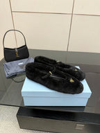 Prada women's black plush loafers with gold logo plate, front view, slip-on