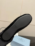 Prada women's black plush loafer sole view, gray rubber outsole