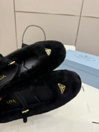 Prada women's black plush loafer with gold triangle logo, close-up on upper