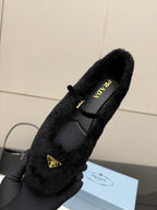 Prada women's black plush loafer in hand, PRADA logo on insole