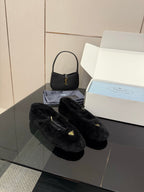 Prada women's black plush loafers with gold logo, side-by-side pair