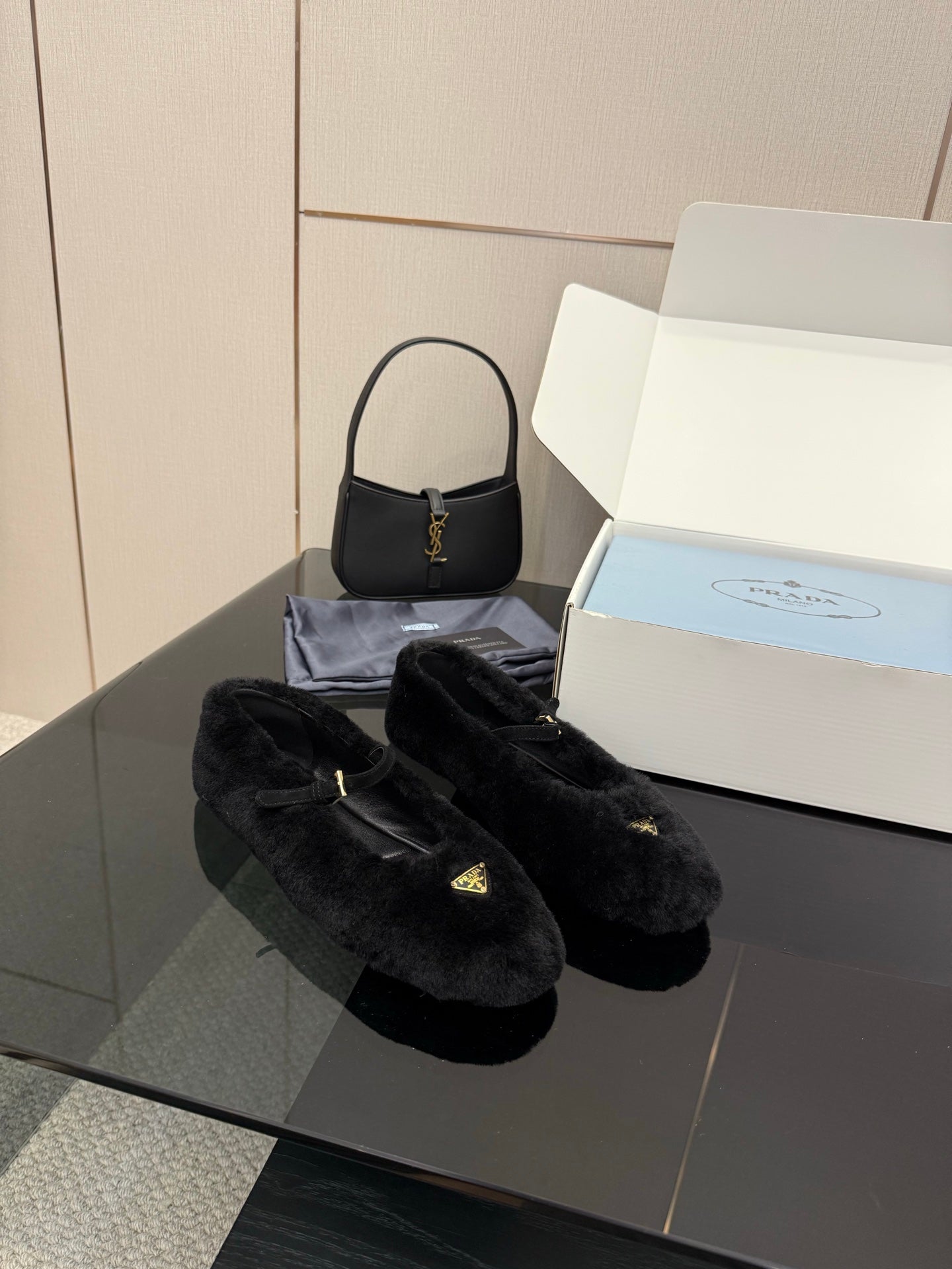 Prada women's black plush loafers with gold logo, side-by-side pair
