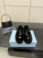 Prada women's black plush loafers with gold logo plaque, slip-on style