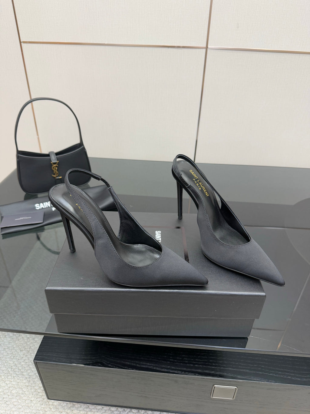 Women’s stiletto heeled pumps, dark leather, angled front view