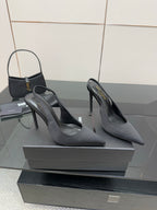 Women’s stiletto heeled pumps, dark leather, angled front view