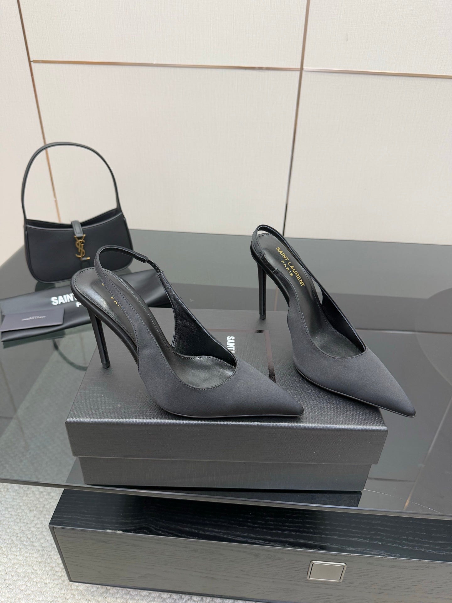 Women’s stiletto heeled pumps, dark leather, angled front view