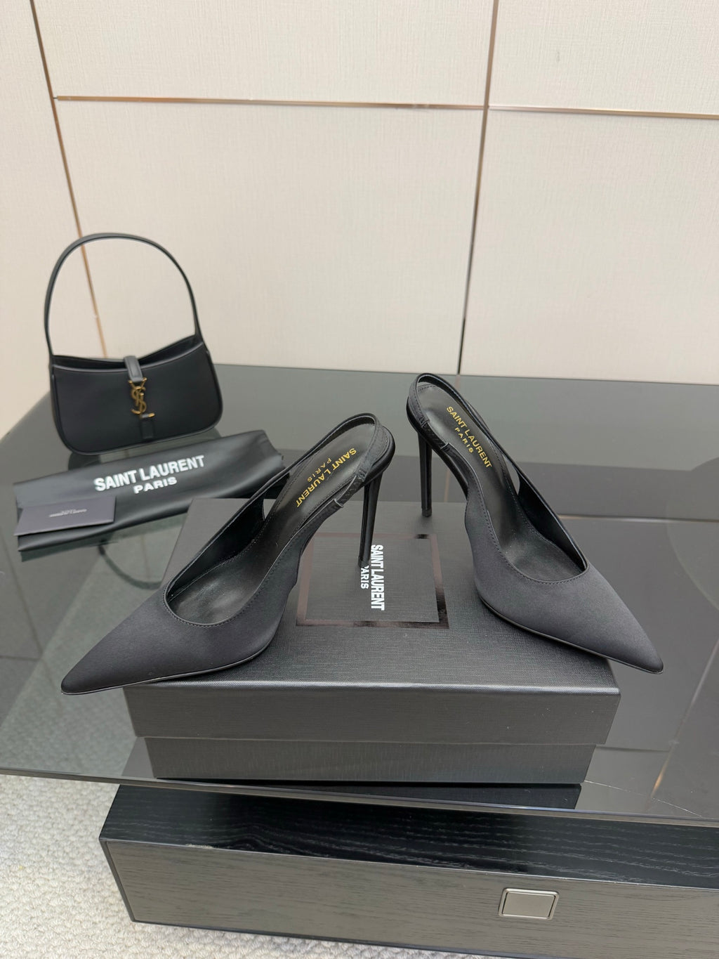 Women’s stiletto heeled pumps, dark leather, heel and toe view